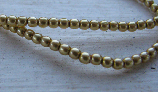 Tjeckiska vaxade glaspärlor - Gold 2mm, 1 sträng