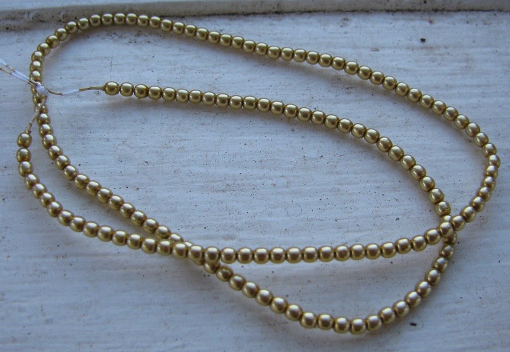 Tjeckiska vaxade glaspärlor - Gold 2mm, 1 sträng